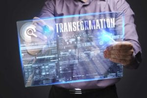 Man in lavendar shirt holding screen with transformation