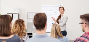 Class room with student explaining at poster board